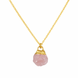 Necklace with a pink stone pendant on a gold chain against a white background
