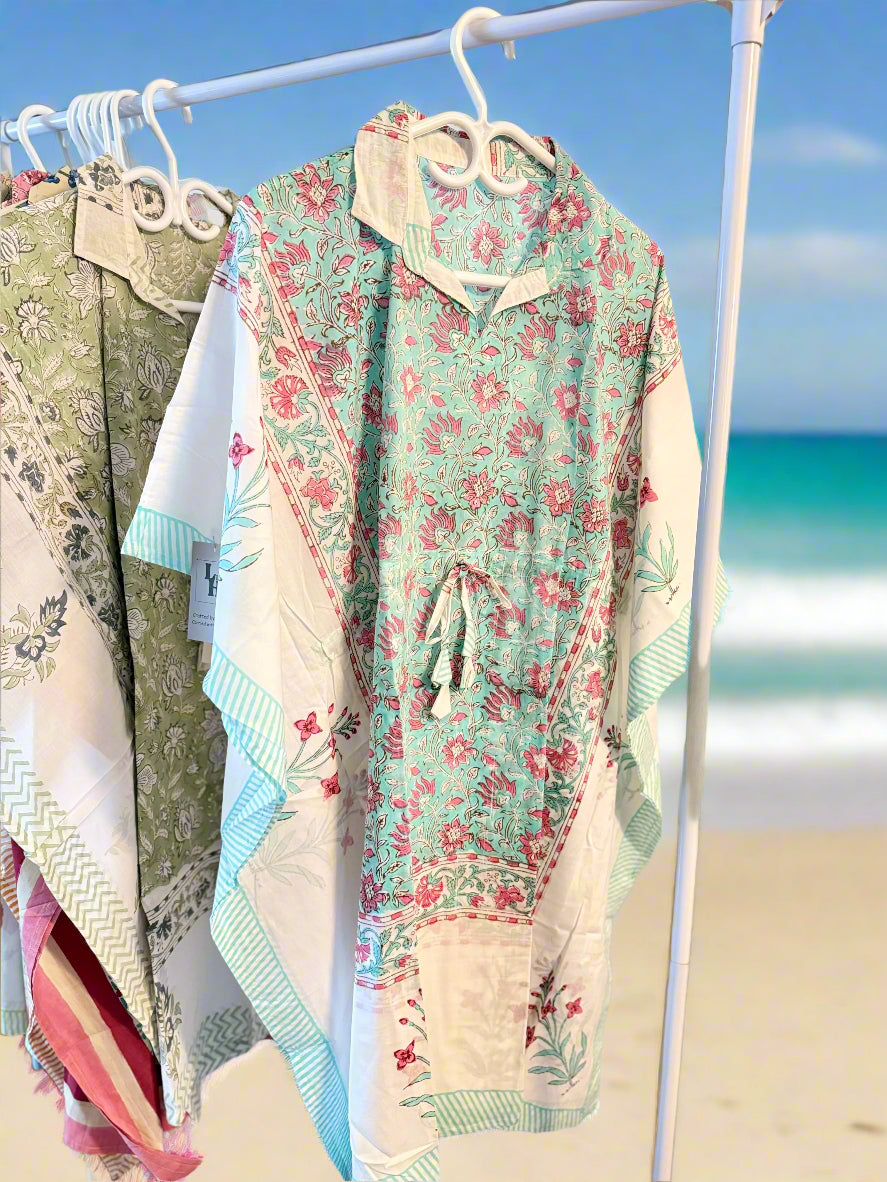 Floral dress on a hanger with a beach background