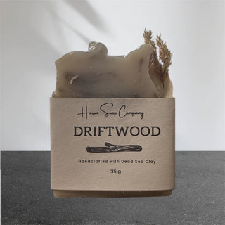 Artisan soap with 'Huron Soap Company Driftwood' label on a gray background