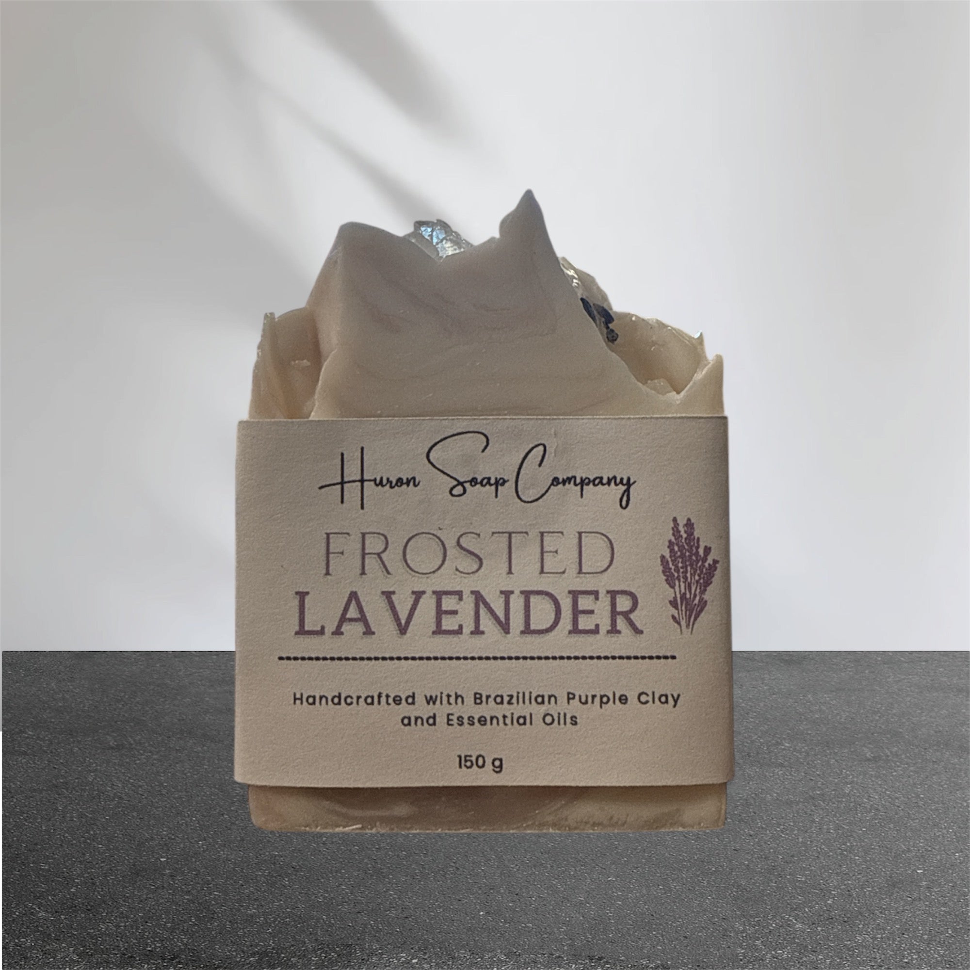 Artisan Soap with 'Huron Soap Company Frosted Lavender' packaging on a gray background