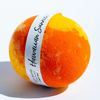 Orange bath bomb with a white label on a light gray background