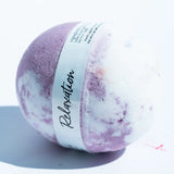 Purple and white bath bomb with 'Relaxation' label on a light background
