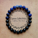 Beaded bracelet with blue and black beads on a beige background with 'Sattva Collections' branding.