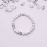 White and gray beaded bracelet on a light gray background