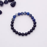 Navy blue beaded bracelet on a white background