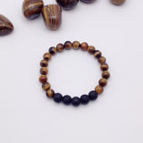 Beaded bracelet with brown and black beads on a white background