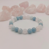 Beaded bracelet with blue and pink stones on a light background