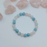 Beaded bracelet with blue and pink beads on a white background