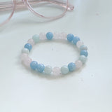 Beaded bracelet with blue and white beads on a light background