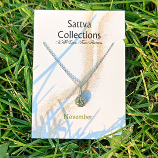 Sattva Collections necklace card on grass