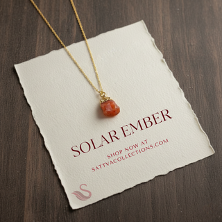 Necklace with a red pendant on a 'Solar Ember' card with branding information.