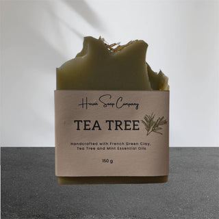 Tea tree artisan soap with packaging from Huron Soap Company on a gray background